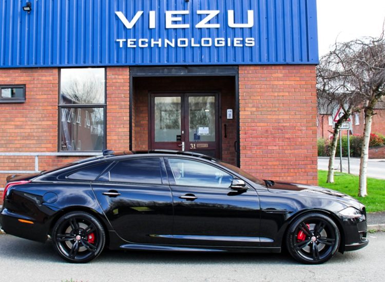 Black Jaguar XJ Tuning side view in front of Viezu building Black Jaguar XJ Tuning side view in front of Viezu building