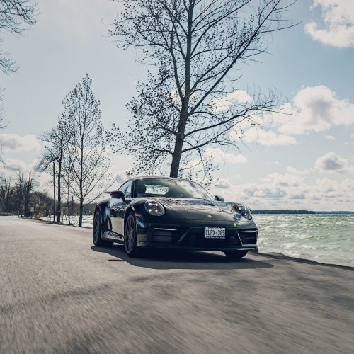 Porsche 911 driving on the road towards the camera for tuning at VIEZU