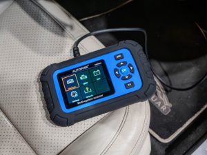 Autophix DM5600 being used in a car for automotive diagnostics