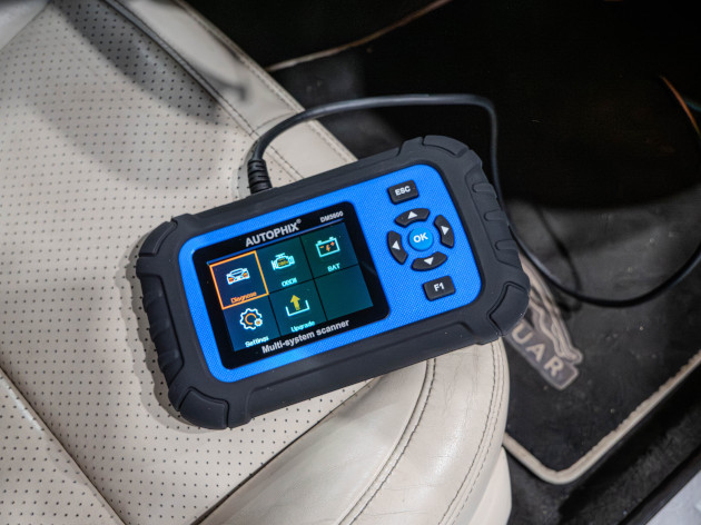 Autophix DM5600 being used in a car for automotive diagnostics